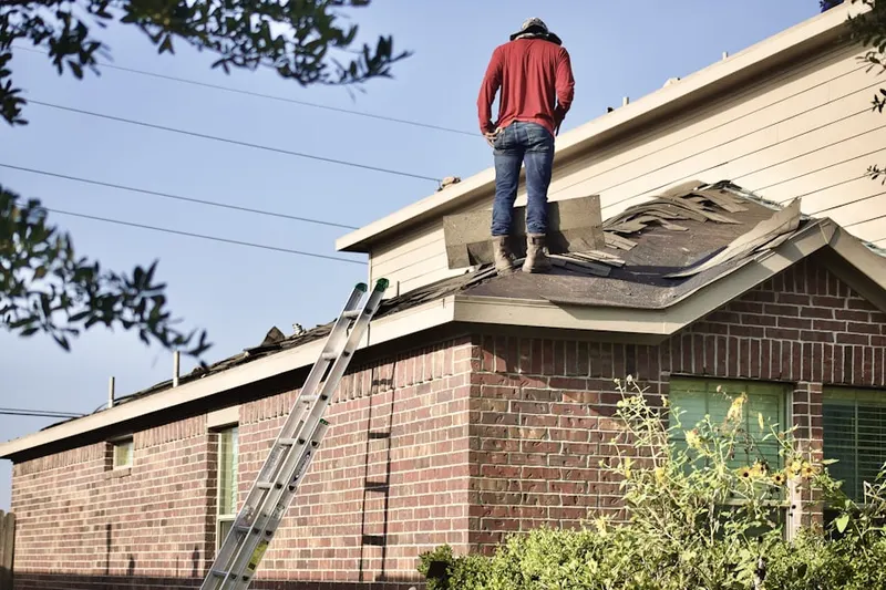 Professional roofer working on a residential roof in Stoneham